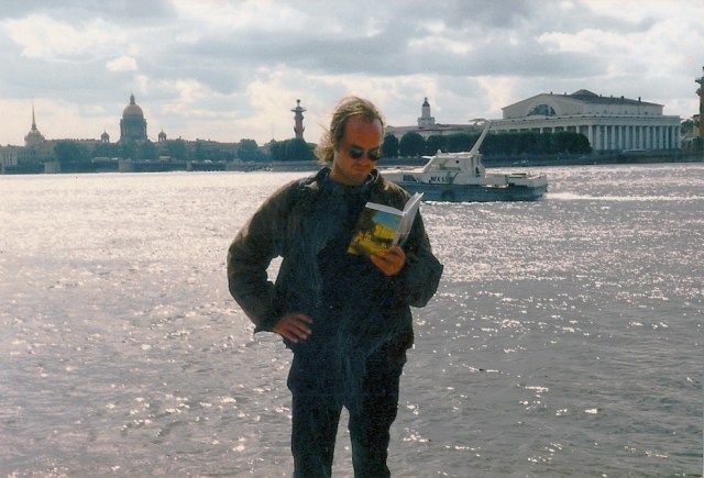 John M. Edwards, "The Manhattan Candidate," reads an outdated Guide to Leningrad in modern-day St. Petersburg, Russia. . . .